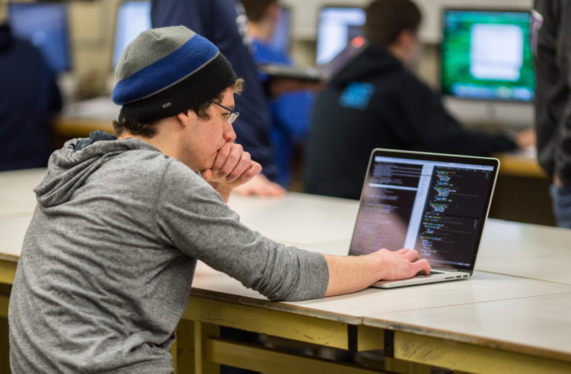 Guy in front of a laptop coding